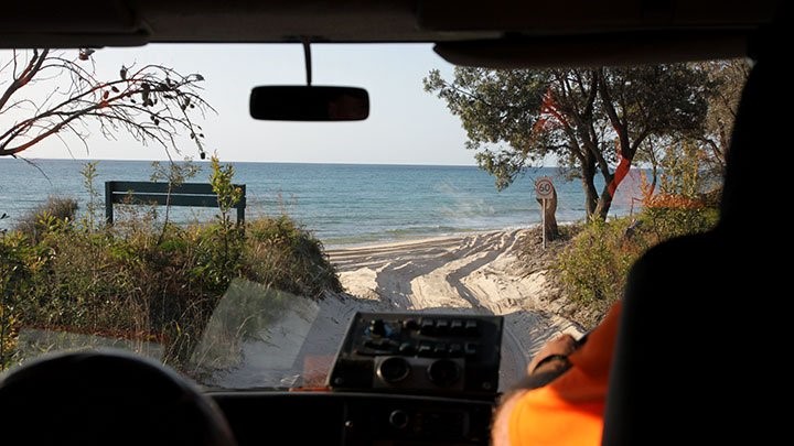 A view of Ocean Beach at Moreton Island through the windshield of a 4WD